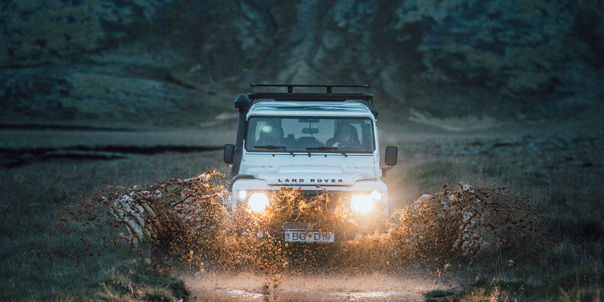 Jeep crossing river in highlands