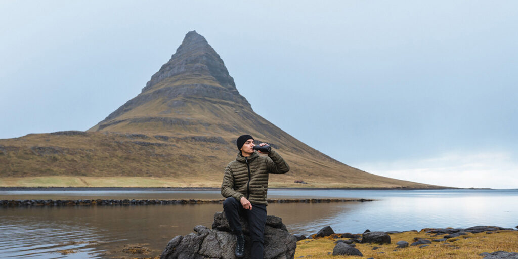 A thirsty traveller drinking water on a stop near Kirkjufell mountain