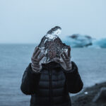 Person holding ice in landscape