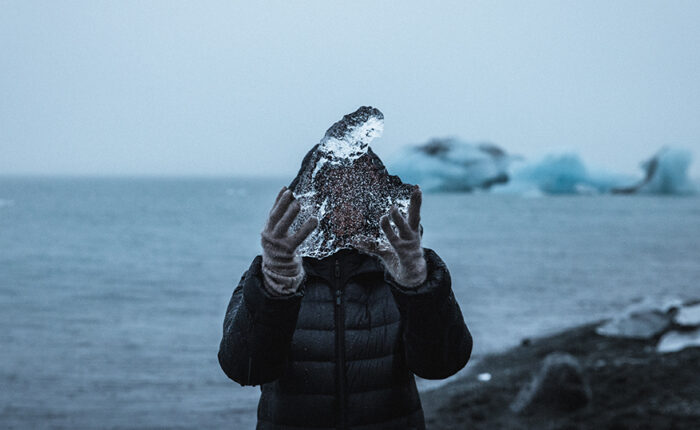 Person holding ice in landscape
