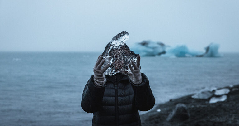 Person holding ice in landscape