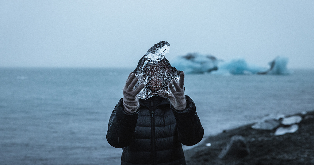 Person holding ice in landscape